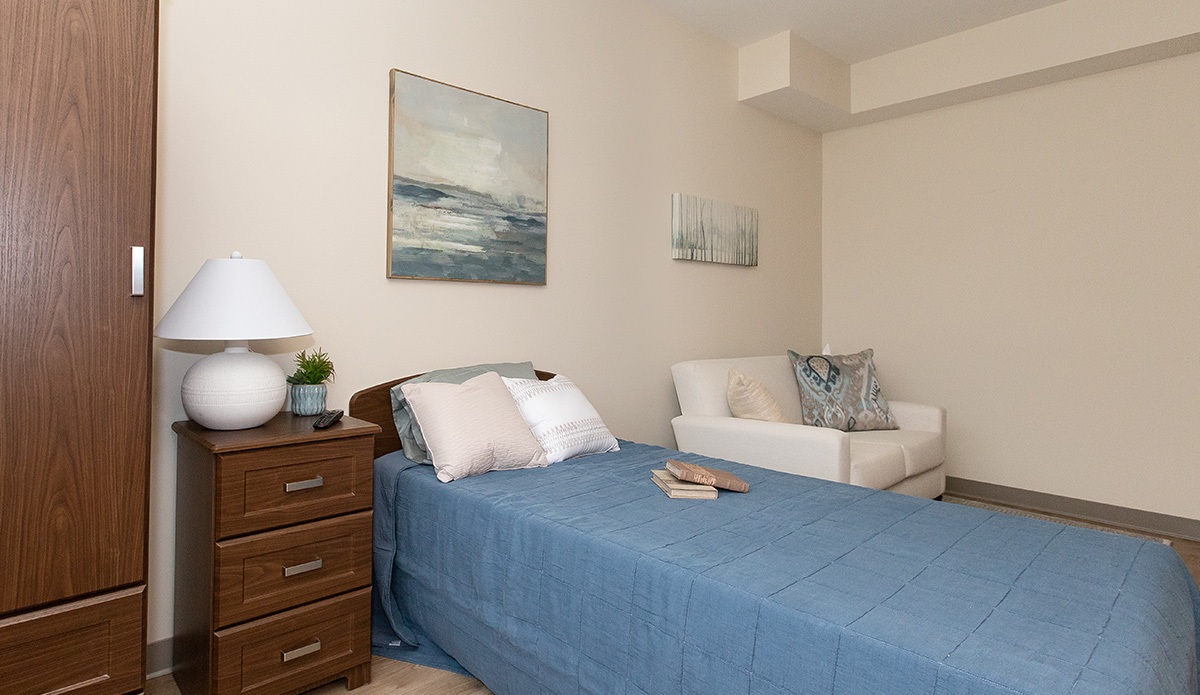 Single bedroom with a cabinet beside bed