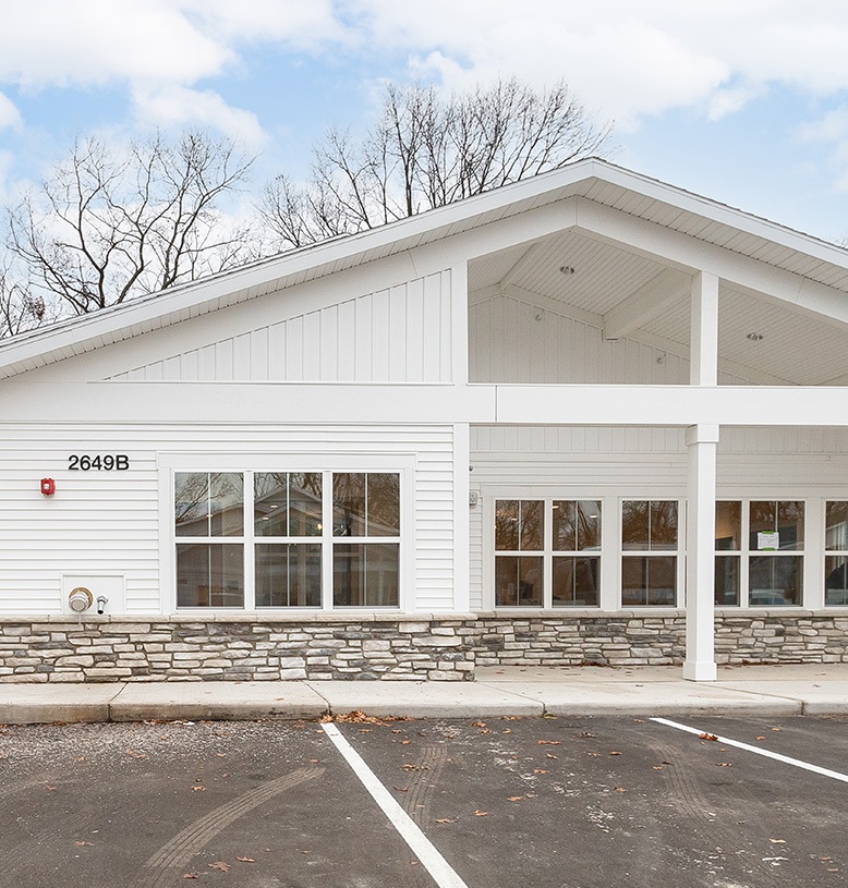 A peaceful senior living community nestled in a scenic valley, showcasing green spaces and cozy homes.